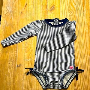 Ruffle Butts 2T, navy stripe, long sleeve, snap enclosure.